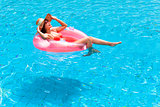 happy Young woman relaxing in swimming pool