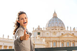 Smiling woman in Vatican City in Rome giving thumbs up