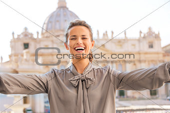 Laughing woman in Vatican City in Rome taking selfie