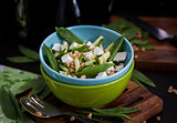 Fresh delicious cucumber, green peas, feta and pine nuts salad