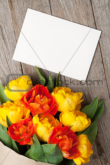 Colorful tulips bouquet and blank greeting card