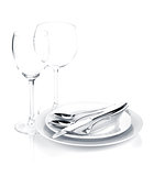 Silverware or flatware set over plates and wine glasses