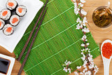 Sushi maki set, green tea and sakura branch