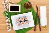 Sushi maki set, green tea and sakura branch