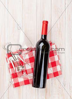 Red wine bottle, glass and corkscrew