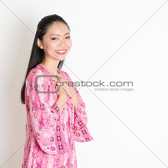 Asian female in pink batik dress