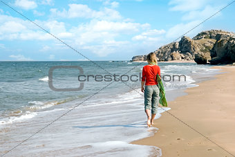 Young woman walking on a beach