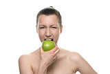 Young Woman Biting Fresh Green Apple Against White