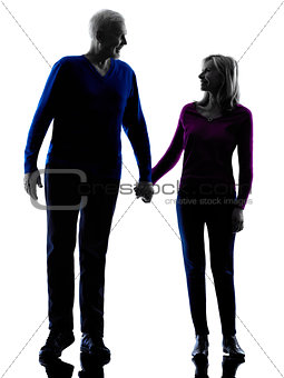 couple senior walking holding hands silhouette