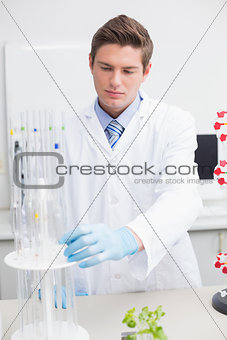 Scientist examining pipette