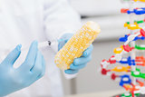 Biologist examining corn with syringe