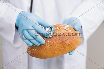Scientist listening bread with stethoscope