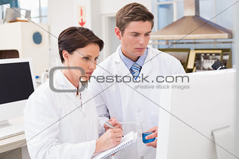 Scientists looking attentively at computer