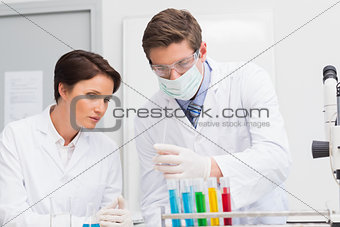 Scientists looking attentively at test tube