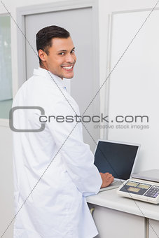 Happy scientist using laptop