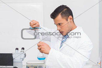 Serious scientist doing tube tests