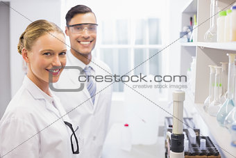 Smiling scientists looking at camera