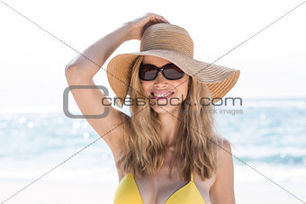 Smiling pretty blonde wearing sun glasses and looking at camera