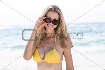 Smiling pretty blonde in bikini looking at camera