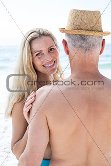Happy couple embracing by the sea