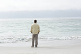 Thoughtful man standing by the sea