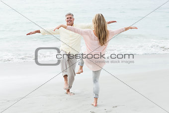 Happy couple doing yoga pose