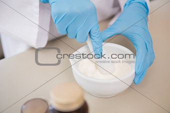 Scientist using pestle and mortar