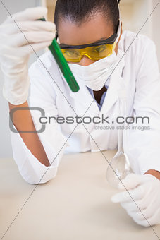 Concentrated scientist analyzing test tube