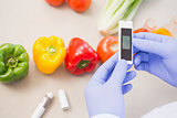 Scientist using device on vegetables