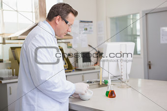 Scientist grinding powder with mortar