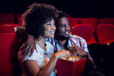 Happy young couple watching a film