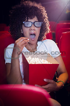 Surprised young woman watching a 3d film