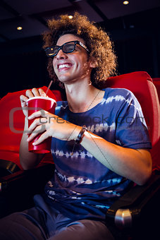 Smiling young man watching a 3d film