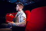 Young man watching a film