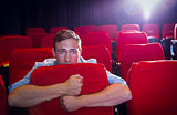 Young man watching a scary film