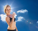 Composite image of fit blonde drinking water