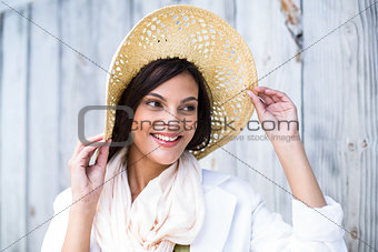 Smiling beautiful brunette wearing straw hat