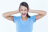 Screaming woman covering her ears