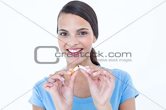 Happy woman breaking a cigarette