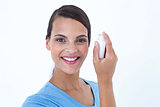Smiling woman using her inhaler