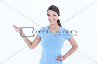 Woman smiling presenting something with her hand