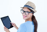 Smiling woman using her tablet looking at camera