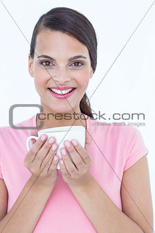Pretty brunette holding coffee cup