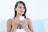 Thoughtful woman holding cup of coffee