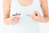 Woman testing her blood glucose level
