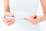 Woman testing her blood glucose level