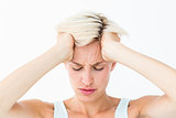 Blonde woman suffering from headache holding her head