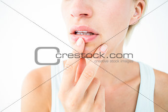 Thoughtful woman touching her lips