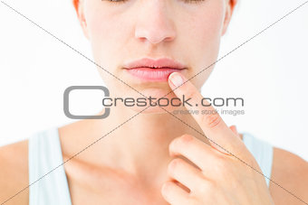 Pretty woman with finger on lip