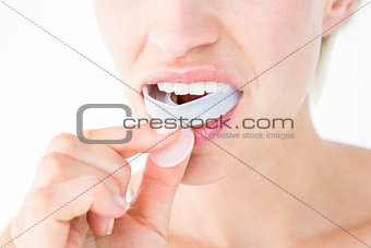 Woman putting her gum shield